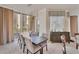 Contemporary dining room with a sleek table, comfortable seating, designer lighting, and bright windows with lovely neighborhood views at 1300 Benjamin Franklin Dr # 304, Sarasota, FL 34236