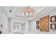 Elegant hallway with decorative lighting, trim and coastal-themed wall art creating a welcoming ambiance at 1300 Benjamin Franklin Dr # 304, Sarasota, FL 34236