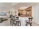 Inviting kitchen with breakfast bar, modern lighting, and seamless flow to living area at 1300 Benjamin Franklin Dr # 304, Sarasota, FL 34236