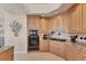 A gourmet kitchen shows wooden cabinetry, stone countertops, modern appliances, and diamond tile accents at 1300 Benjamin Franklin Dr # 304, Sarasota, FL 34236