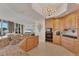 Gourmet kitchen boasts wooden cabinets, granite counters, modern appliances, open concept to the living room, and great natural lighting at 1300 Benjamin Franklin Dr # 304, Sarasota, FL 34236