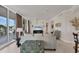 Stylish living room featuring tile floors, modern furniture, and a large sliding glass door to the balcony at 1300 Benjamin Franklin Dr # 304, Sarasota, FL 34236