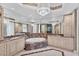 Opulent bathroom with a jacuzzi tub, dual sinks with marble countertops, decorative wall mirrors, and a grand chandelier at 1300 Benjamin Franklin Dr # 304, Sarasota, FL 34236