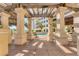 An outdoor pool area, as seen from the shaded patio, offers views of the beach and local condo community at 1300 Benjamin Franklin Dr # 304, Sarasota, FL 34236