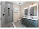 Bathroom featuring a double sink vanity, shower with glass door, and decorative tile flooring at 1301 12Th S St, St Petersburg, FL 33705