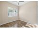 Bedroom with wood-look tile flooring and bright natural light at 1301 12Th S St, St Petersburg, FL 33705