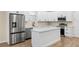 Bright kitchen featuring an island, white cabinets, stainless steel appliances, and modern fixtures at 1301 12Th S St, St Petersburg, FL 33705