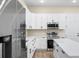 Bright kitchen featuring an island, white cabinets, stainless steel appliances, and modern fixtures at 1301 12Th S St, St Petersburg, FL 33705