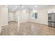 Spacious open-concept living area featuring wood-look tile floors, abundant natural light, and modern finishes at 1301 12Th S St, St Petersburg, FL 33705