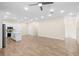 Open-concept living room showcasing modern kitchen island and stainless steel appliances under recessed lighting at 1301 12Th S St, St Petersburg, FL 33705