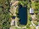 An aerial view of a residence showcasing a pond and natural surroundings at 1471 Arcadia Ave, Sarasota, FL 34232