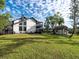 Lush backyard featuring a well-maintained lawn, storage shed, and a charming two-story home at 1471 Arcadia Ave, Sarasota, FL 34232