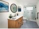 Modern bathroom features a glass-enclosed shower, new vanity with quartz countertop, and coastal-themed decorations at 1471 Arcadia Ave, Sarasota, FL 34232