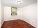 Cozy bedroom with beautiful wood floor, large windows with a serene outdoor view, and neutral paint at 1471 Arcadia Ave, Sarasota, FL 34232