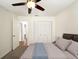 Cozy bedroom showcasing a comfortable bed, closet, ceiling fan, and warm, inviting decor at 1471 Arcadia Ave, Sarasota, FL 34232