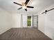 Bright bedroom featuring neutral walls, a ceiling fan, sliding barn door and private balcony access at 1471 Arcadia Ave, Sarasota, FL 34232
