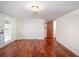 Spacious bedroom with wood floor, walk-in closet with louvered doors, and an adjacent door to the attic at 1471 Arcadia Ave, Sarasota, FL 34232