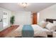 Cozy bedroom features wood floors, neutral walls, walk-in closet, and French doors to a balcony at 1471 Arcadia Ave, Sarasota, FL 34232