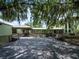 Spacious wooden deck offers a relaxing outdoor space with benches and overhead covering at 1471 Arcadia Ave, Sarasota, FL 34232