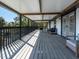 Large covered deck featuring an outdoor living space with wooded area views at 1471 Arcadia Ave, Sarasota, FL 34232