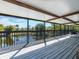 Large covered deck featuring an outdoor living space with lake views at 1471 Arcadia Ave, Sarasota, FL 34232