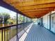 Expansive covered deck overlooking a serene lake and lush greenery, perfect for outdoor enjoyment at 1471 Arcadia Ave, Sarasota, FL 34232