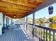 Spacious covered deck with wood flooring, ceiling fan, railing, and water view at 1471 Arcadia Ave, Sarasota, FL 34232