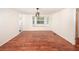 Bright and airy dining room with beautiful wood floors and natural light from the bay window at 1471 Arcadia Ave, Sarasota, FL 34232