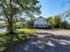Exterior view of home with large deck space overlooking the lush backyard and pond at 1471 Arcadia Ave, Sarasota, FL 34232