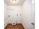 Cozy laundry area featuring white walls, wood-look floors, and washer/dryer hookups at 1471 Arcadia Ave, Sarasota, FL 34232