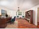 Well-lit office space with hardwood floors, a desk, bookcase, and comfortable seating for a productive work environment at 1471 Arcadia Ave, Sarasota, FL 34232