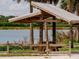 Covered picnic pavilion offers shaded relaxation by a serene lake at 1471 Arcadia Ave, Sarasota, FL 34232