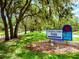 Colonial Oaks Park sign is surrounded by lush greenery along a park road at 1471 Arcadia Ave, Sarasota, FL 34232