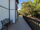 The porch has a bench and a long view at 1471 Arcadia Ave, Sarasota, FL 34232