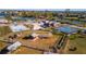 Aerial view of community amenities featuring tennis courts, basketball court, and playground at 15 Seaside Ct, Holmes Beach, FL 34217