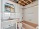 Dated bathroom with peach-colored fixtures, white tile, and open ceiling at 15 Seaside Ct, Holmes Beach, FL 34217