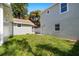 Spacious backyard featuring lush green grass, fenced perimeter, and a detached structure at 1739 16Th S Ave, St Petersburg, FL 33712