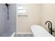 Bright bathroom featuring a modern soaking tub, stylish tile floor, and a sleek black faucet at 1739 16Th S Ave, St Petersburg, FL 33712
