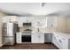 Modern kitchen with white cabinets, stainless steel appliances, and sleek countertops at 1739 16Th S Ave, St Petersburg, FL 33712