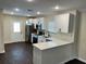 Updated kitchen boasts stainless appliances, white cabinets, and a breakfast bar with stylish countertop at 1739 16Th S Ave, St Petersburg, FL 33712
