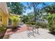 Outdoor patio features a dining table and chairs, palm trees, and plenty of yard space at 1870 Jasmine Dr, Sarasota, FL 34239