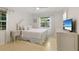 Cozy bedroom showcasing great natural light from the window and a modern television in the corner at 1870 Jasmine Dr, Sarasota, FL 34239