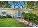 Inviting front entrance with a decorative walkway, tiled landing, and charming details at 1870 Jasmine Dr, Sarasota, FL 34239