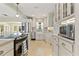 Spacious updated kitchen featuring white cabinets, stainless steel appliances, and granite countertops at 1870 Jasmine Dr, Sarasota, FL 34239