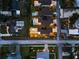 Aerial nighttime view showcases a modern home's pool and landscaping with elegant outdoor lighting at 2305 Pine Ter, Sarasota, FL 34231