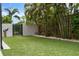 Backyard featuring artificial turf and landscaping, enclosed by a modern fence at 2305 Pine Ter, Sarasota, FL 34231