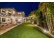 Outdoor space showcasing lush artificial turf and ambient string lights for evening enjoyment at 2305 Pine Ter, Sarasota, FL 34231