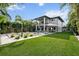 Sprawling backyard with a modern home, inviting pool, lush lawn, and stylish outdoor living spaces at 2305 Pine Ter, Sarasota, FL 34231