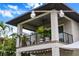 Charming balcony adorned with potted plants, offering a cozy outdoor space with a stylish ceiling fan at 2305 Pine Ter, Sarasota, FL 34231