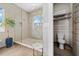 Bathroom featuring a glass shower, tiled walls, and stacked towels at 2305 Pine Ter, Sarasota, FL 34231